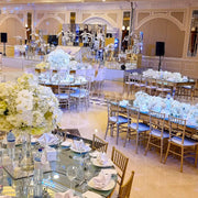 Decorated banquet hall with tables set for a formal event - Moments rentals