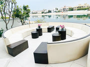 Modern outdoor furniture set with black and white design by a waterfront.