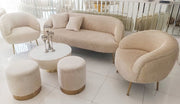 Beige furniture set including a sofa, chairs, and ottomans in a modern living room.