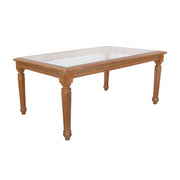 Wooden dining table with a glass top on a white background
