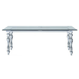 A modern console table featuring a clear glass rectangular top supported by ornate, sculptural glass legs with a fluted, baroque-inspired design.