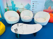 Beige Velvet Single seater Sofas around a marble table with a colourful backdrop featuring world landmarks.