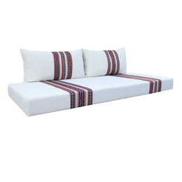White sofa with striped cushions on a white background