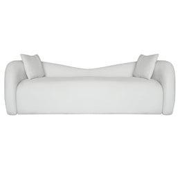 A modern Beige upholstered sofa with rounded arms, a low curved backrest, and two matching white throw pillows, shown against a plain white background.
