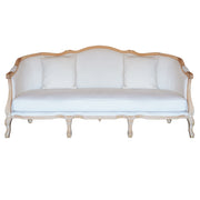 A classic French provincial style three-seater sofa with a light natural wood frame and white fabric upholstery, shown against a plain white background.