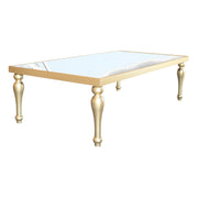 Gold-framed table with a white glass top on a white background