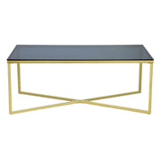 Coffee table with black glass top and gold metal frame on a white background