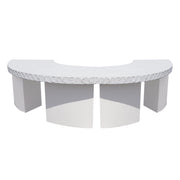 White curved table with decorative stone design on a white background