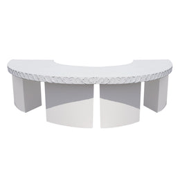 White curved table with decorative stone design on a white background
