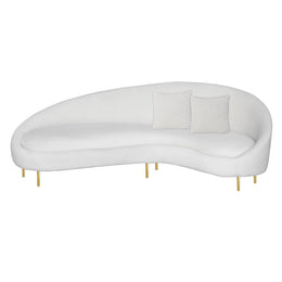 A modern curved white velvet sofa with two square white throw pillows and slim gold metal legs, shown against a plain white background.