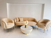 Beige sofa set with matching armchairs and a small round table in a modern interior setting.