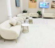 Modern white sofa set with gold legs in a stylish room.