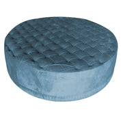 Tufted Blue round ottoman on a white background