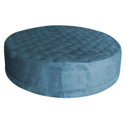 Blue round ottoman with tufted design on a white background