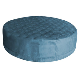 Blue round ottoman with tufted design on a white background