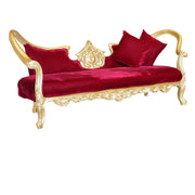 Red velvet sofa with gold frame and red cushions on a white background
