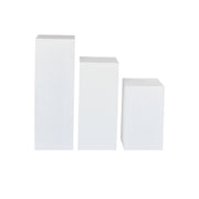 Three white flower display stand of different sizes on a white background