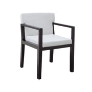 A modern armchair with a dark brown wooden frame and white upholstered seat and back cushions, shown on a plain white background.