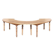Wooden curved table with turned legs on a white background