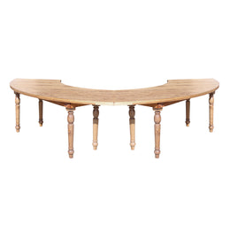 Wooden curved table with turned legs on a white background