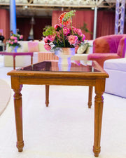 Wooden table with a floral arrangement in a decorated indoor setting