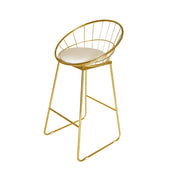 Gold metal bar stool with a white cushion on a white background
