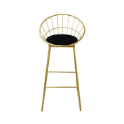 Gold metal bar stool with black cushion on a white background