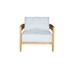 A modern armchair with a light natural wood frame and plush, light blue-gray cushions on the seat and backrest, shown against a plain white background.