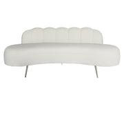 A modern curved Beige velvet upholstered bench with a scalloped backrest and slim metallic legs.