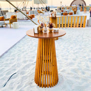 Wooden Cocktail table with decorative items on a sandy beach setting in Dubai