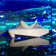 Beige Velvet Sofa in front of a vibrant underwater scene with fish and lights.