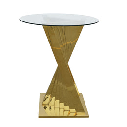 A modern cocktail table with a clear glass top and a reflective, sculptural metallic gold base, shown on a solid white background.