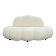 Modern velvet sofa with a cloud-like design on a white background
