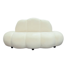 Modern velvet sofa with a cloud-like design on a white background