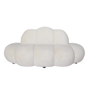 A modern cloud-shaped sofa beige velvet upholstery 