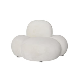A modern, cloud-like sofa in beige velvet upholstery