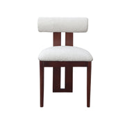 A modern dining chair with a textured off-white bouclé seat and backrest cushion, supported by a dark reddish-brown wooden frame, shown against a plain white background.