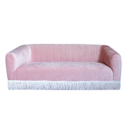 Pink sofa with white fringe on a white background