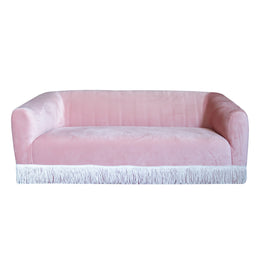 Pink sofa with white fringe on a white background