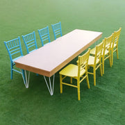 Long table with blue and yellow Kids chairs on a green background