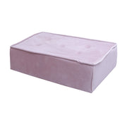 Pink cushioned pouf on a white background