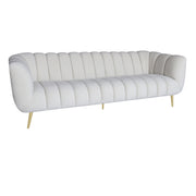 A modern white tufted loveseat sofa with gold metal legs, shown from a three-quarters angle on a solid white background.