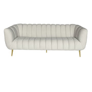 A modern beige velvet tufted loveseat sofa with curved arms and slim gold metal legs.