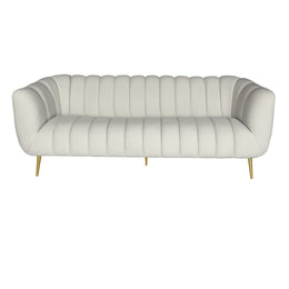 A modern beige velvet tufted loveseat sofa with curved arms and slim gold metal legs.
