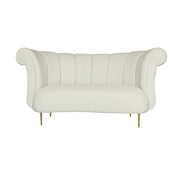 A beige velvet upholstered loveseat with a curved silhouette, vertical channel tufting on the backrest, rolled arms, and slim gold metal legs.