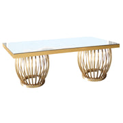 Dinning table with gold metal base and glass top on a white background