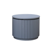 A modern cylindrical side table with a ribbed fluted metal body and a flat circular top, shown on a plain white background.