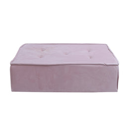 Pink ottoman with tufted design on a white background