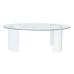 Round glass table with white ribbed base on a white background