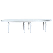 Round glass dining table with white legs on a white background moments Rentals